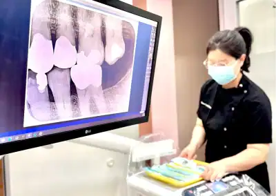 Dental professional examining X-ray image