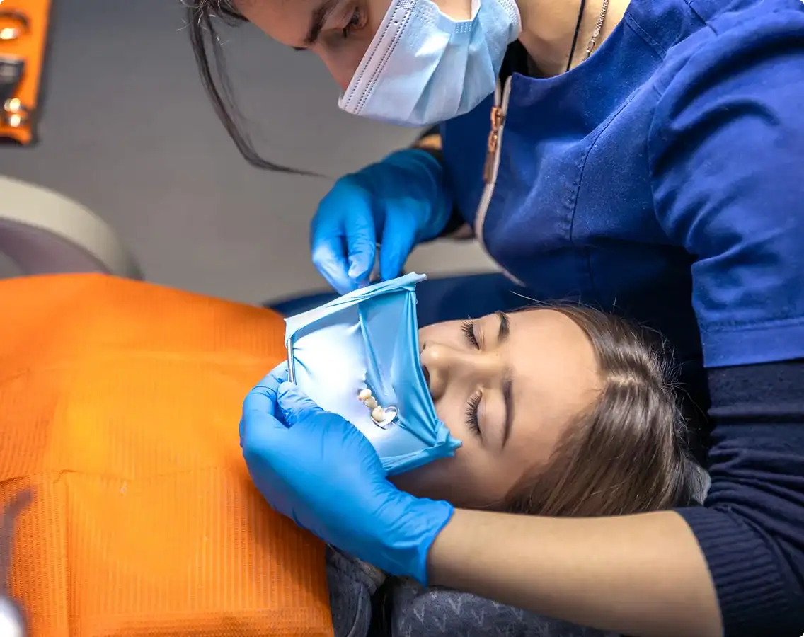 Smiling woman pointing at her teeth