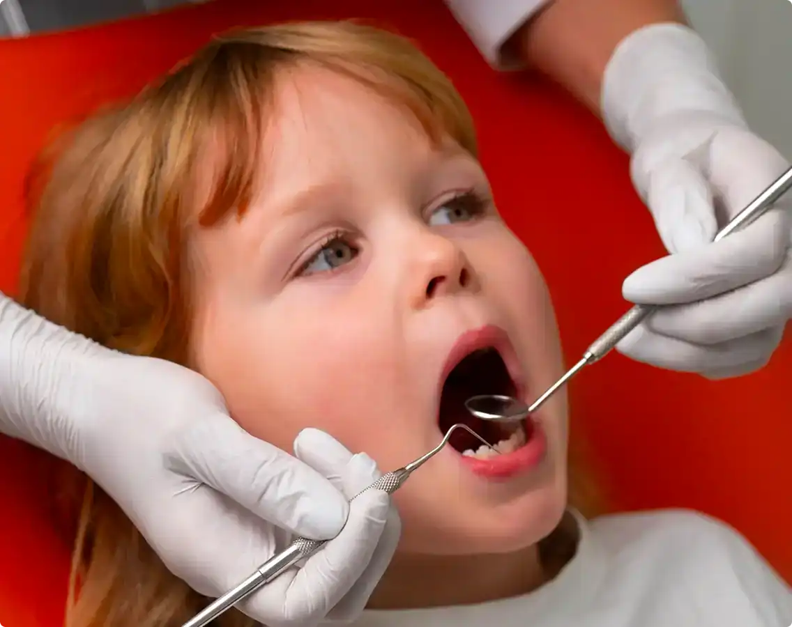 Dentist checking a young child's teeth at Prahran Family Dental