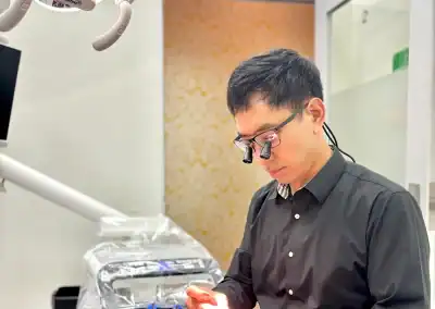 Dentist examining dental tools carefully.