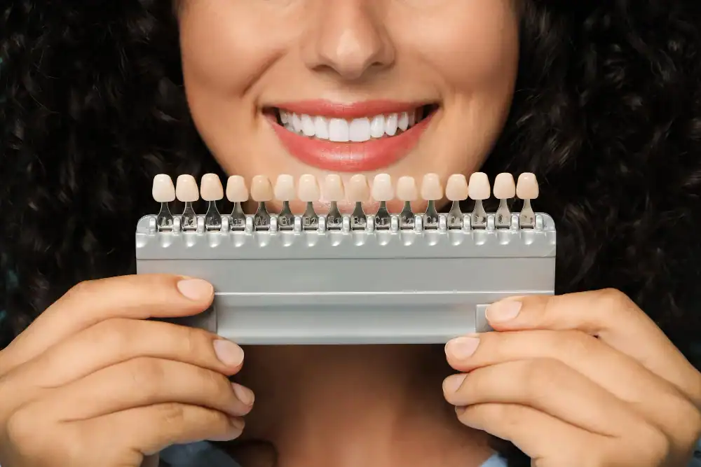 Porcelain Veneers in Prahran Smiling woman holding dental veneers