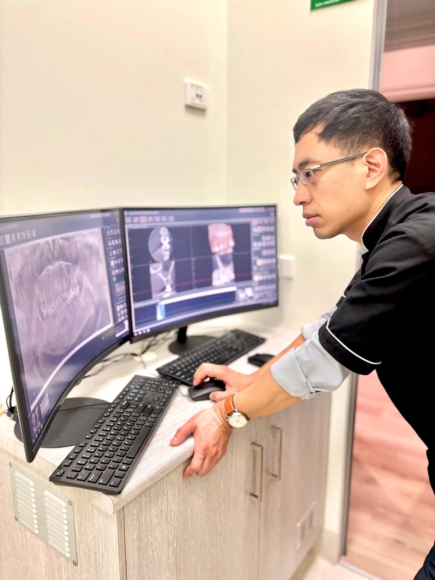 Dr Jun Kim reviewing a dental Xray in Prahran
