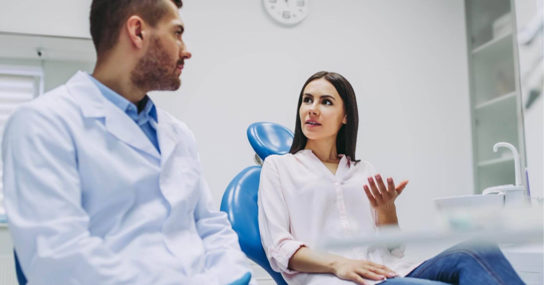 patient talking with the dentist while seated in the dental chair in Prahran