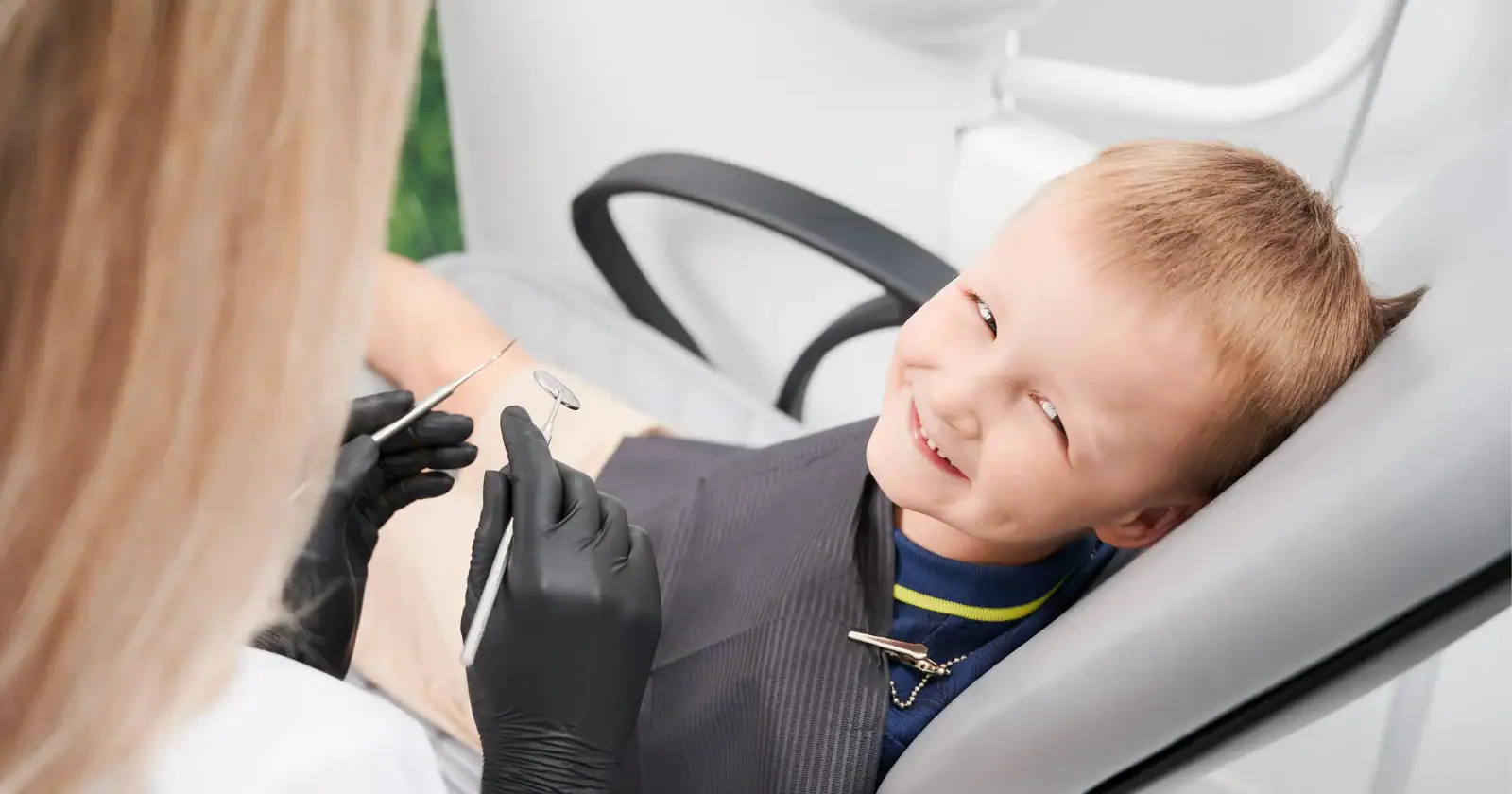 Smiling child in a dental chair with a dentist in Prahran
